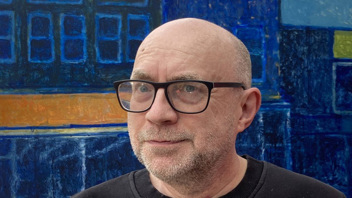 Jonathan Hooper with a painting in the studio
